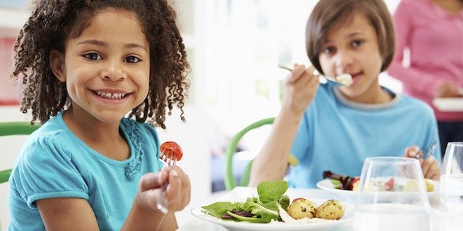 African American Family Eating Meal At Home Together Child eating meal