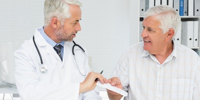 Male doctor giving a prescription to his senior patient medication and senior