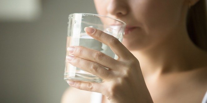 Female drinking from a glass of water thirsty sign diabetes
