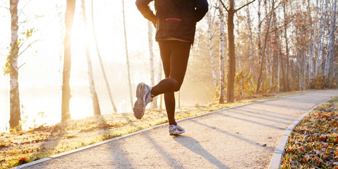 Man running at autumn during sunrise