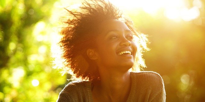 Beautiful african american woman smiling with sunset stay positive