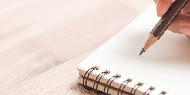 Hands writing on notebook reverse diabetes - count calories