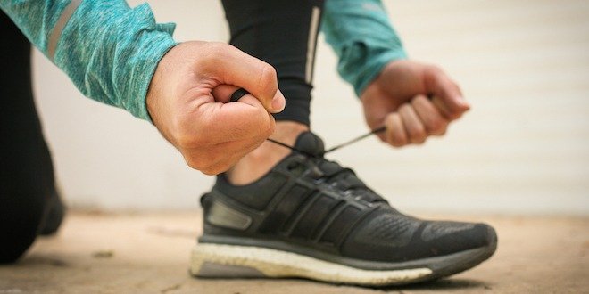 Man tying shoes before running. reverse diabetes - increase physical activity