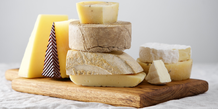 Various kind of cheese, traditional pieces of Spanish, French, Italy cheese. Light background with copy space, table with gray linen tablecloth Assortment of cheeses