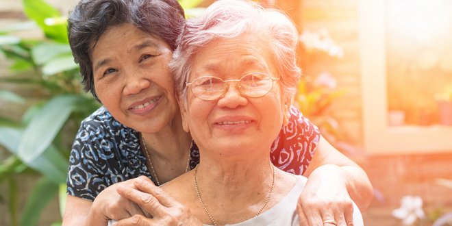 Happy senior friendship society concept. Portrait of Asian female older ageing women smiling with happiness in garden at home, nursing home, or wellbeing county mother daugther