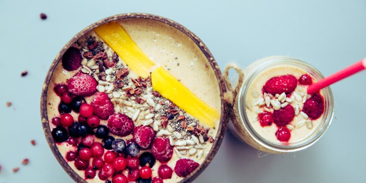 Smoothie bowl with mango, rasberry, blueberry, granola and chia seeds fruit and chia seeds