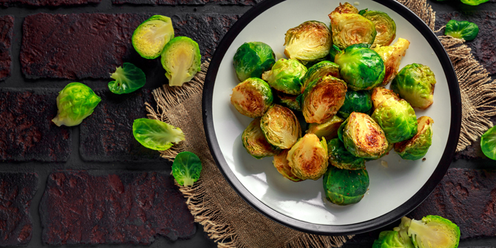 Homemade Roasted Brussel Sprouts with Salt, Pepper on a old stone rustic table
