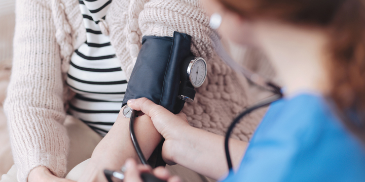 Scaled up look on nurse checking arterial pressure