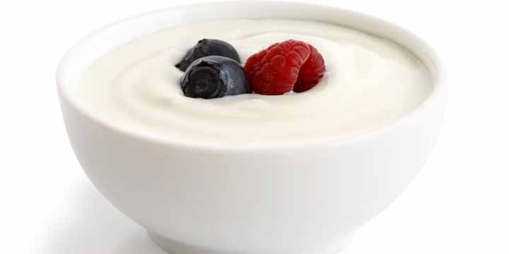 Bowl of white yoghurt with berries isolated on white bac yogurt