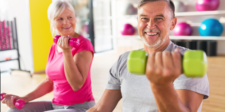 Senior couple lifting dumbbells