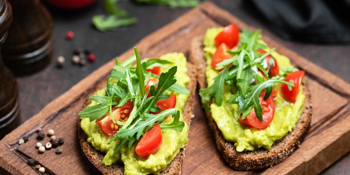 Toast with mashed avocado, arugula