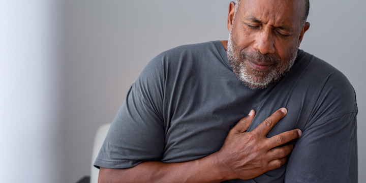 Portrait of an older senior man having chest pain.