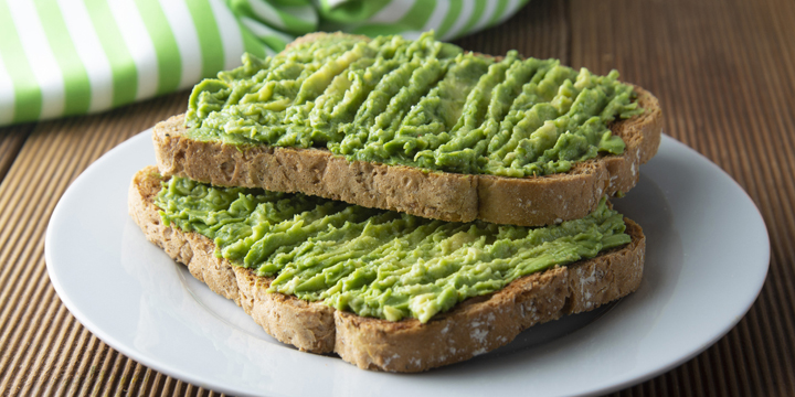 Healthy avocado sandwich, toast bread. Mushed avocado paste, on wooden background. Guacamole. best bedtime snacks