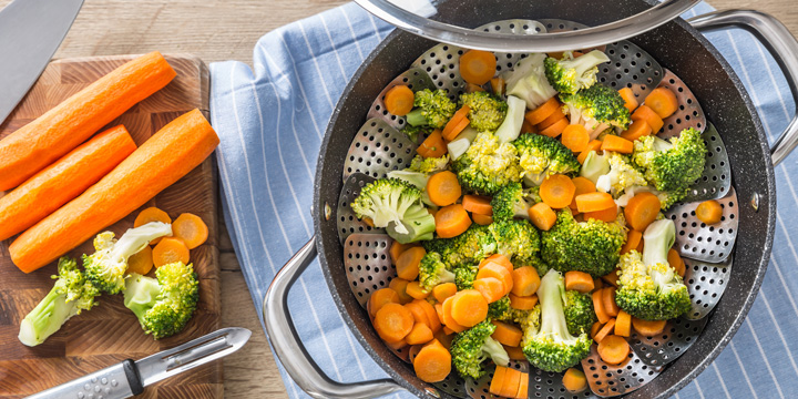 Steamed mixed vegetable in black pot. Healthy vegetable concept