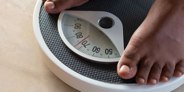 Male on the weight scale for check weight. Diet and weight loss concept.