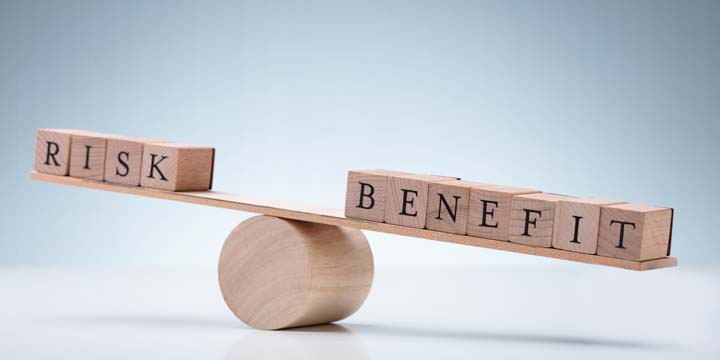 Wooden Block With Risk And Benefit Wooden Block On Seesaw risk reward