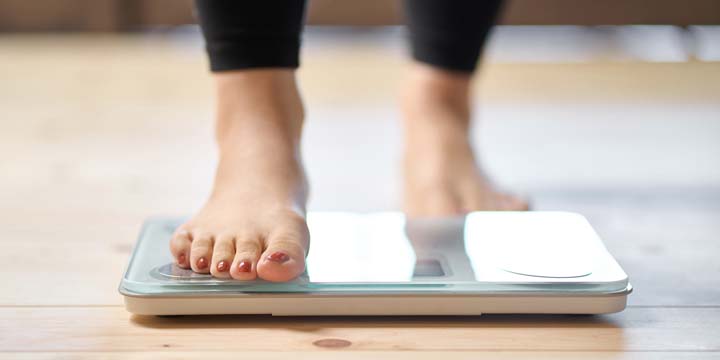 Feet of an Asian woman on a weight scale weight loss